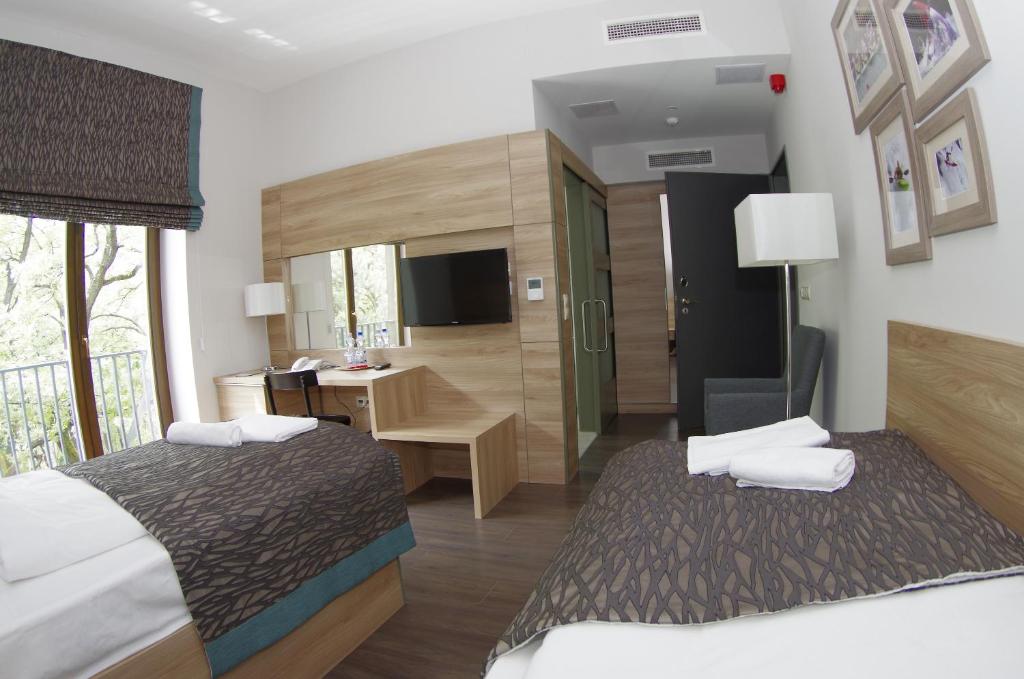 Postel nebo postele na pokoji v ubytování Hotel Therapia