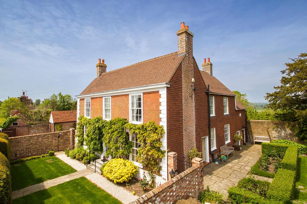 a brick house with a garden in front of it at Boreham House in Herstmonceux