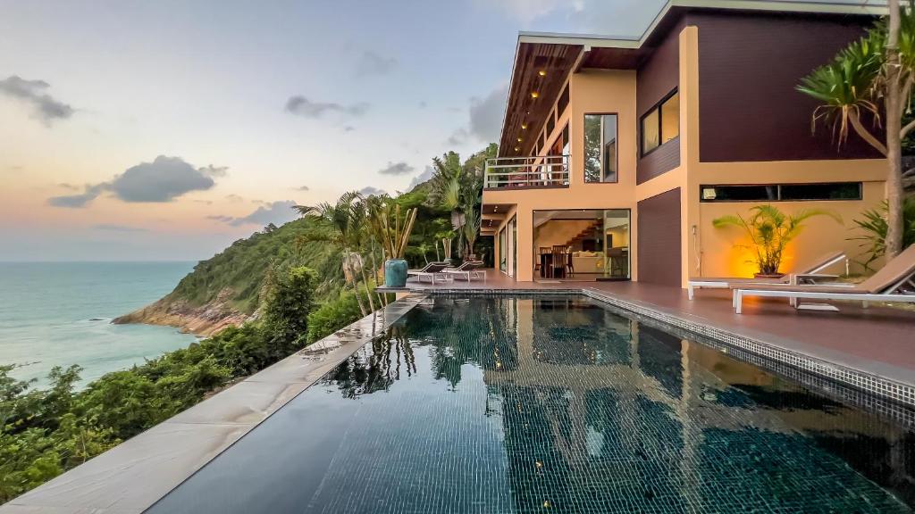 a villa with a swimming pool overlooking the ocean at The Hideaway in Thong Nai Pan Noi
