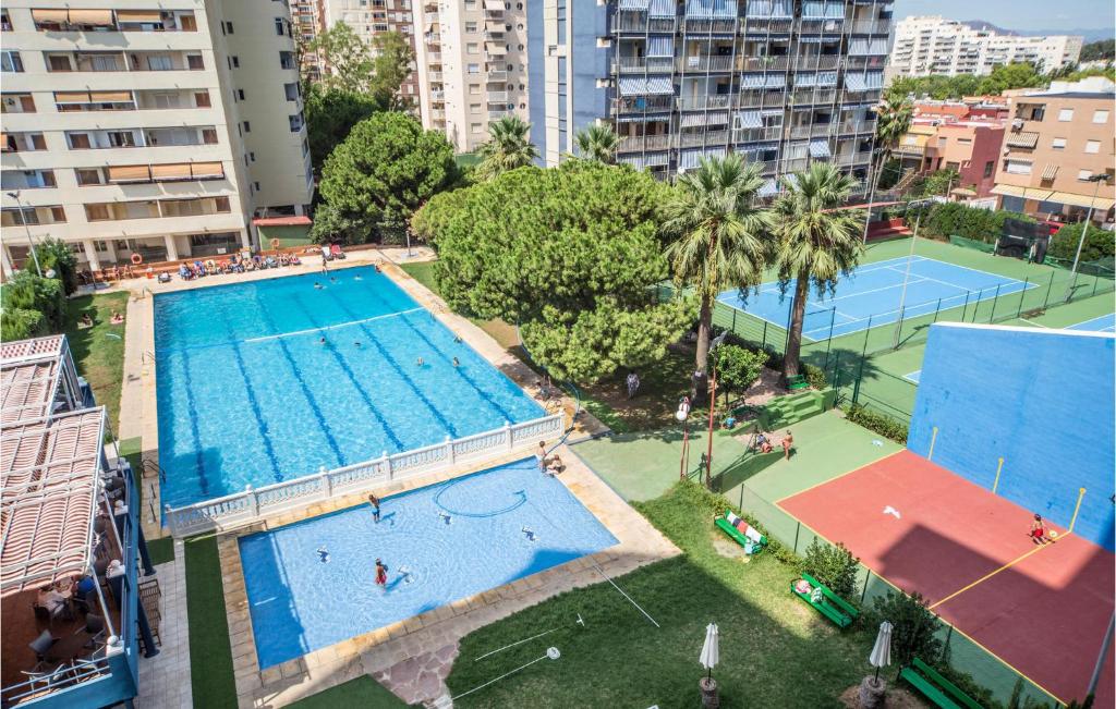 an overhead view of a swimming pool and tennis courts at 1 Bedroom Awesome Apartment In Puebla De Farnals in Puebla de Farnals