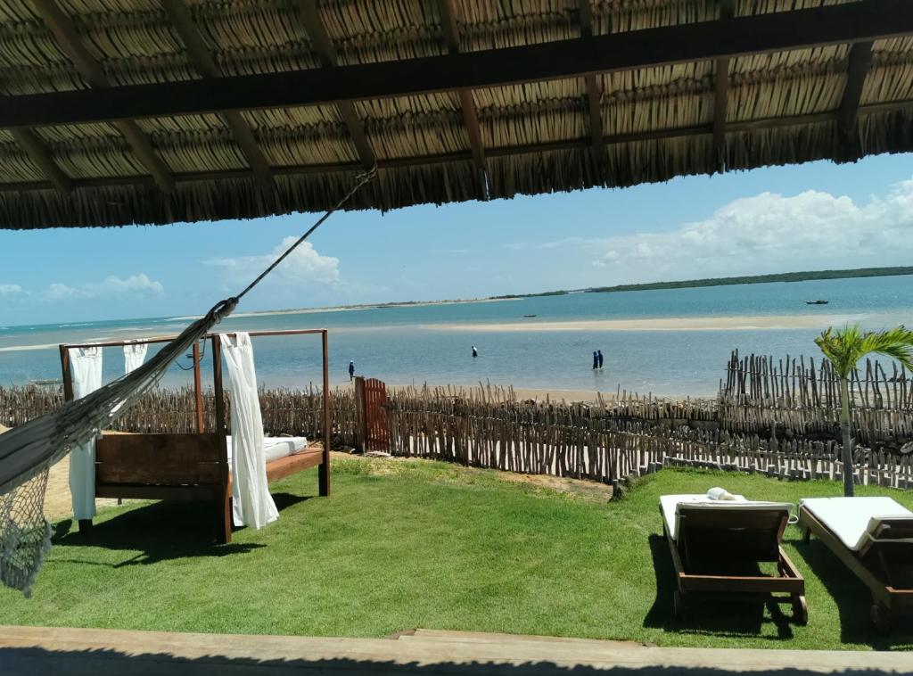 a view of the beach from the porch of a beach house at Beach Bungalow-KiteAliCori , Macapa' in Luis Correia