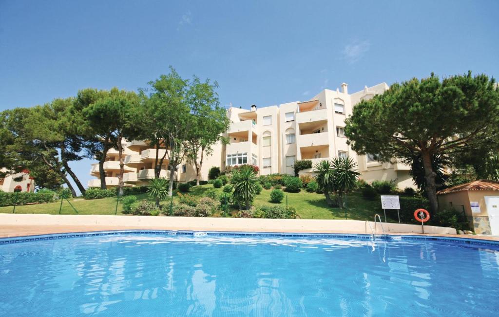 a large swimming pool in front of a building at Beautiful Apartment In Rivera Del Sol With 2 Bedrooms, Wifi And Outdoor Swimming Pool in La Cala de Mijas