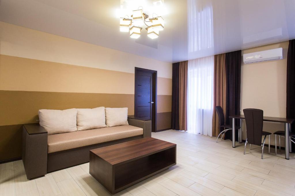a living room with a couch and a table at Luxury One bedrooms 23 August in Kharkiv