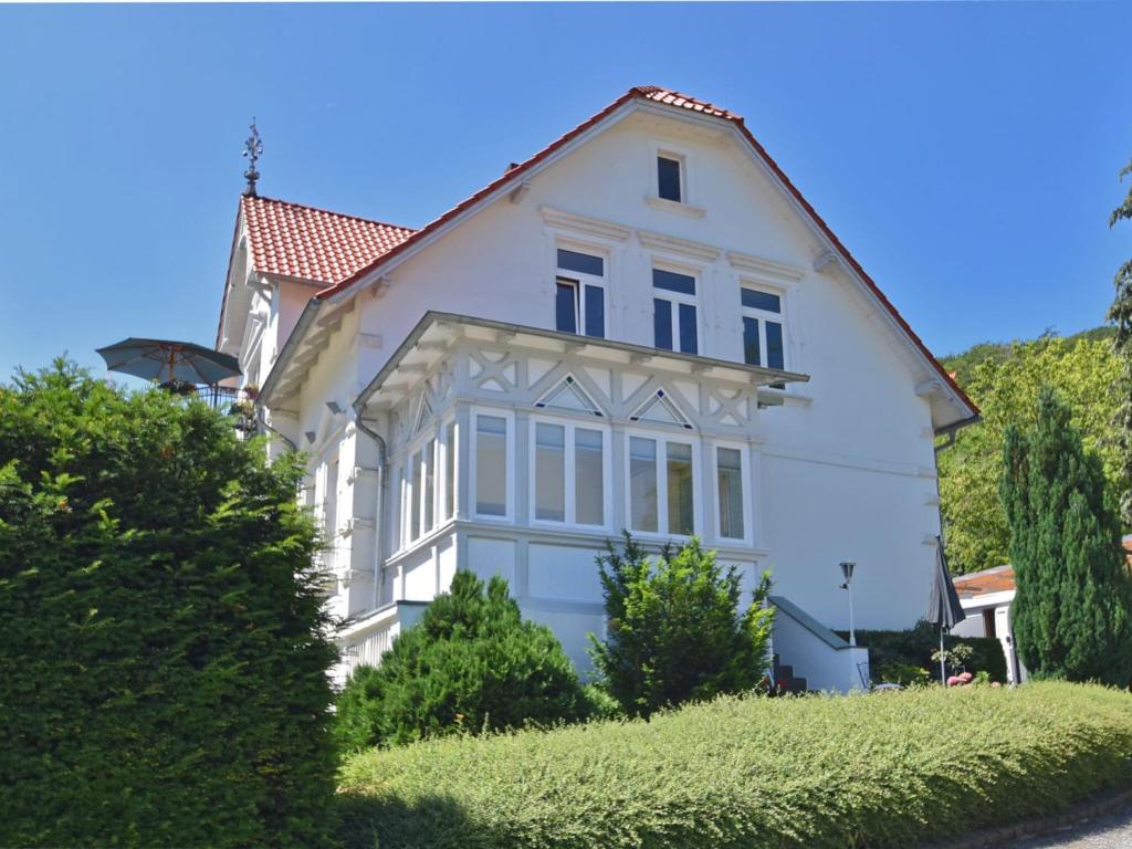 a white house with a red roof at ground floor apartment in Blankenburg in Blankenburg