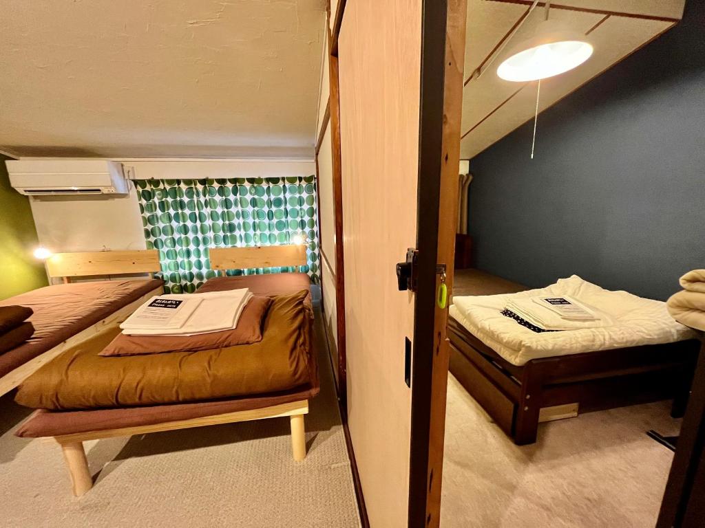 Postel nebo postele na pokoji v ubytování Shared house TATEMACHI in Gujo Hachiman
