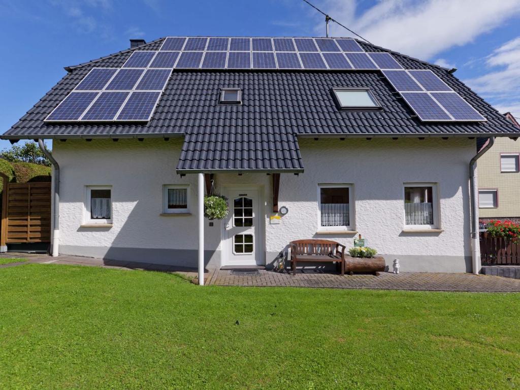 a house with solar panels on the roof at Modern Apartment in Bolsdorf with Sauna in Dohm-Lammersdorf