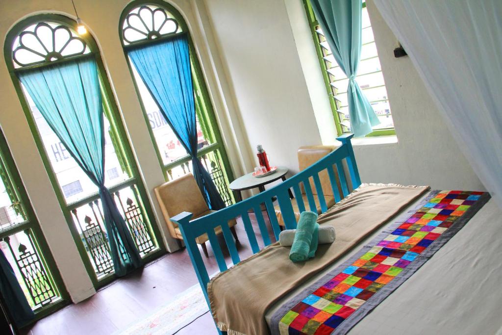 a bedroom with a crib in front of windows at MoonTree47 in George Town