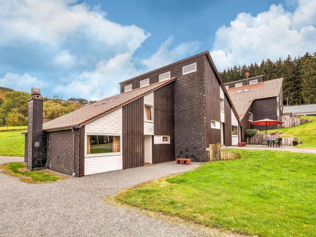 a large brick house with a garage at Ferienhaus mit herrlicher Aussicht in Schmallenberg