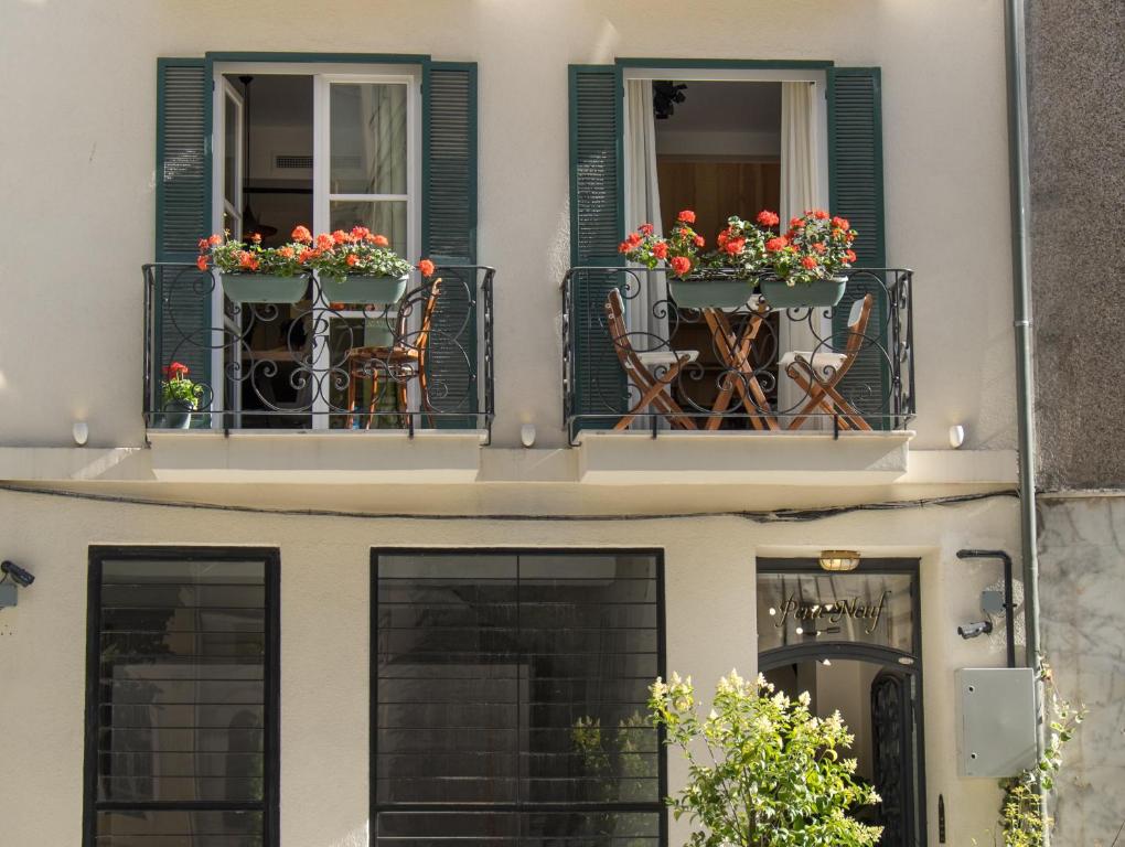 
a patio with a balcony and a window with flowers in it at Pera Neuf in Istanbul
