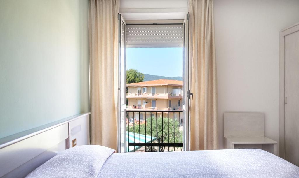Postel nebo postele na pokoji v ubytování Hotel Al Gabbiano