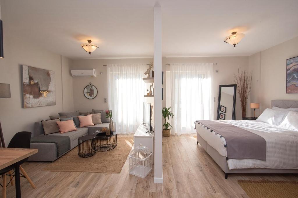 a bedroom and living room with a bed and a couch at Chrysalis 1 in Kos