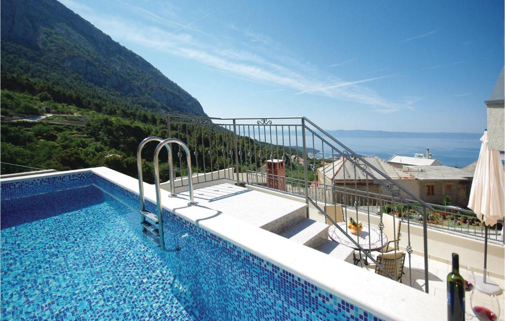 a swimming pool with a view of a mountain at Cozy Home In Makarska With Kitchen in Makarska