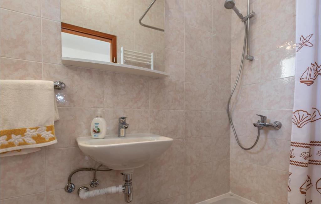 a bathroom with a sink and a shower at Cozy Home In Makarska With Kitchen in Makarska