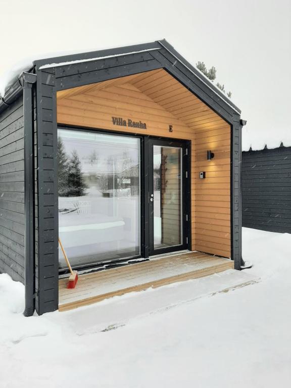 un pequeño cobertizo con una gran puerta de cristal en Willa Rauha G, en Lumijoki