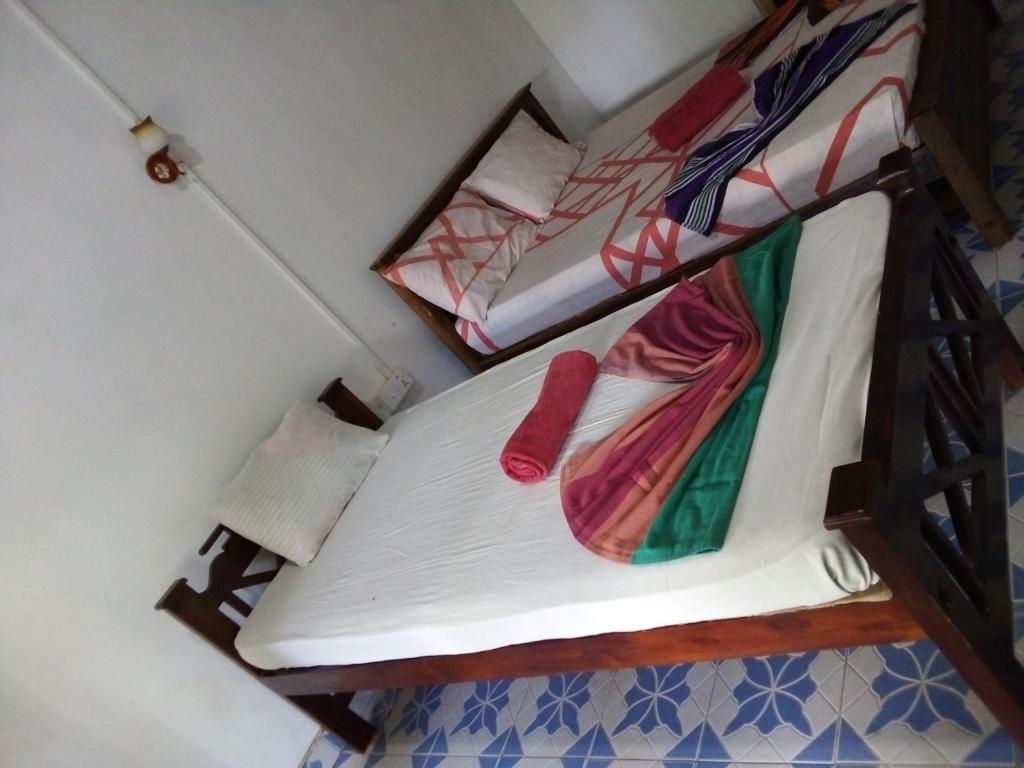 Postel nebo postele na pokoji v ubytování Bandula Home Stay