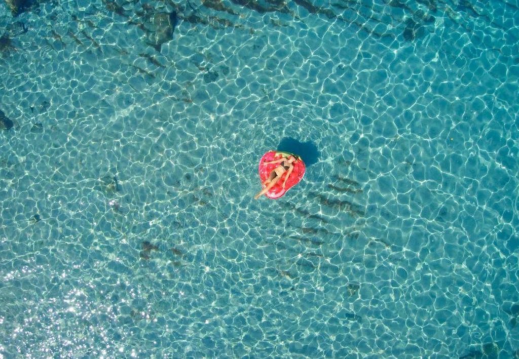 a red ball in a pool of water at Hotel resort Rocca di Vadaro in Capo Vaticano
