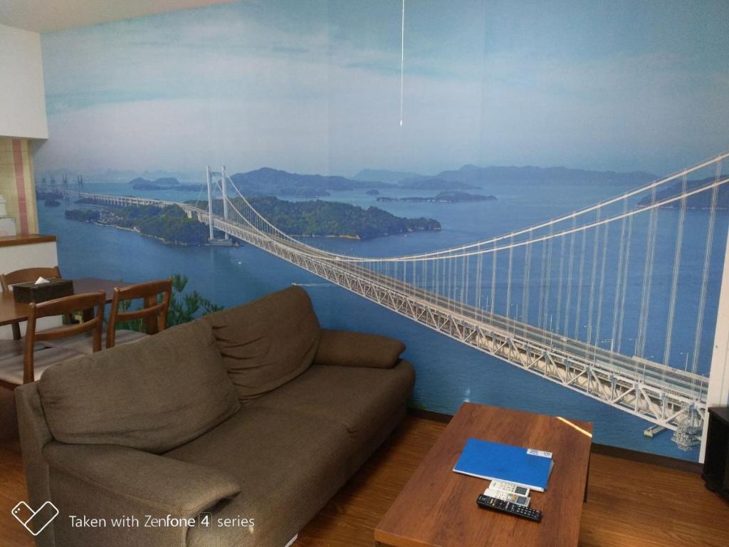 a living room with a mural of a bridge at Maison Ota Building A Building B - Vacation STAY 11139 in Takamatsu