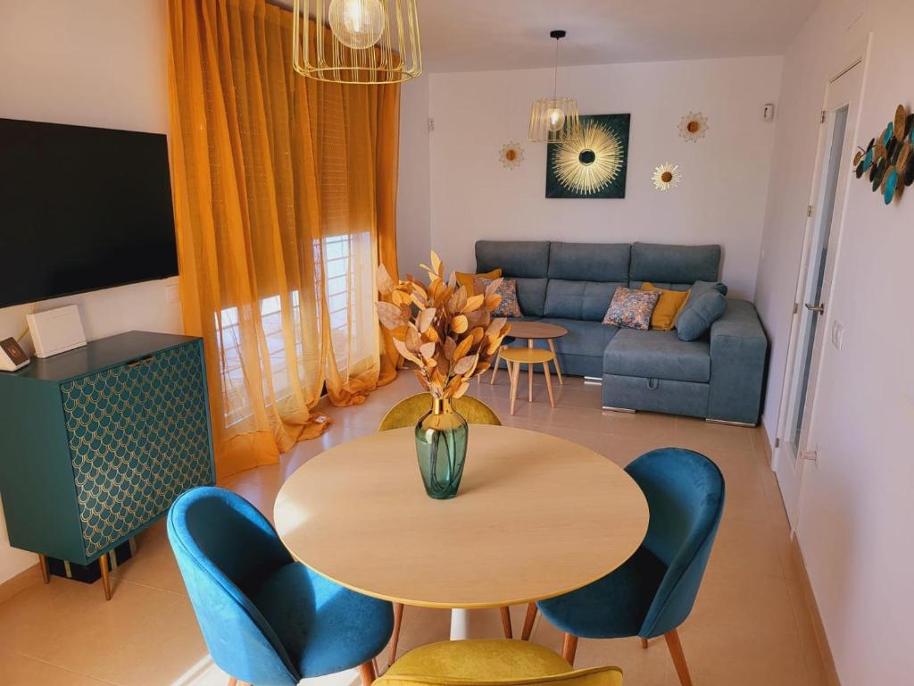 a living room with a table and chairs and a couch at La Paz del Mediterráneo in Garrucha