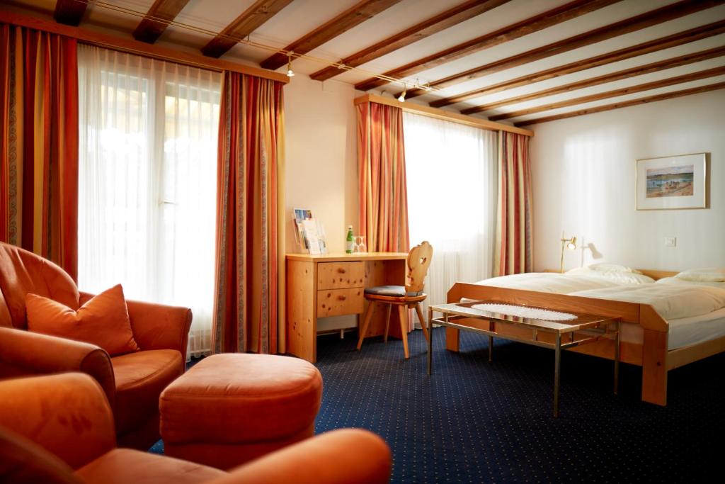 Postel nebo postele na pokoji v ubytování Casanna Hotel Davos City Center