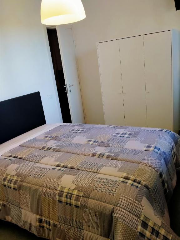 um quarto com uma cama com um cobertor xadrez em Eleonora Bed and breakfast em Muscoline