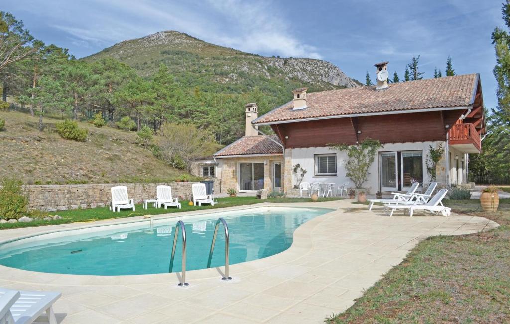 a house with a swimming pool in front of a house at Amazing Home In La Bastide With 5 Bedrooms And Outdoor Swimming Pool in La Bastide