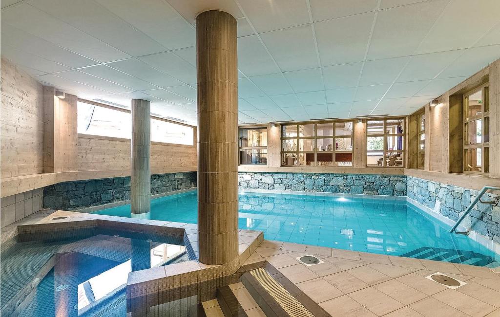 a large swimming pool in a building at Les Fermes miguy in Les Gets