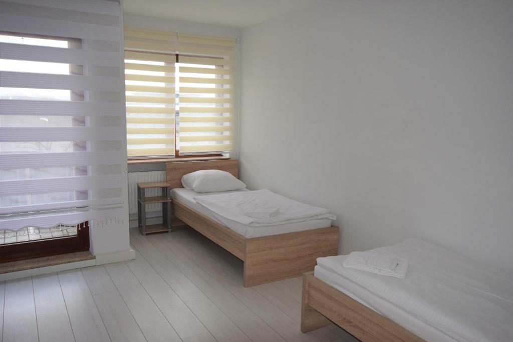 a small room with two beds and a window at AB Apartment Waiblingen in Waiblingen