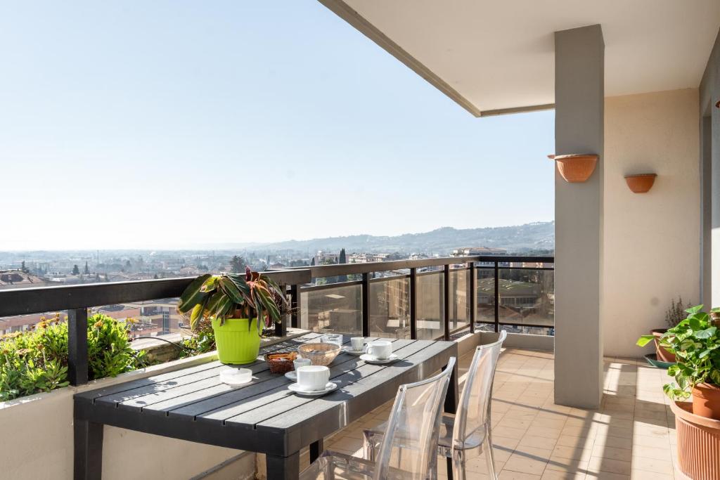 a table and chairs on a balcony with a view at Ponte San Giovanni Terrace Apartment in Ponte San Giovanni