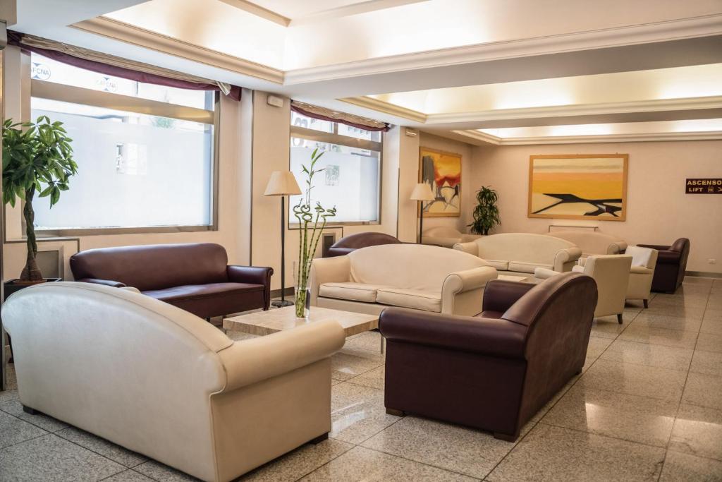 a waiting room with couches and chairs at Hotel Mediterraneo in Palermo