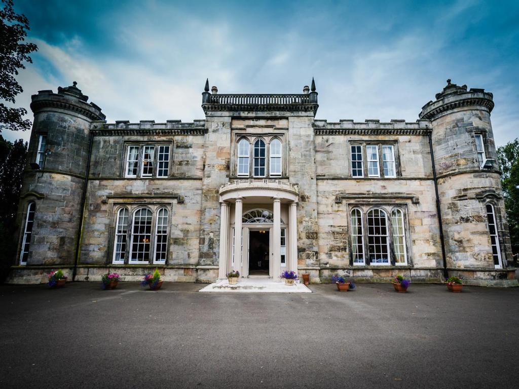 an old stone building with a large entrance at Kincaid House Hotel in Kirkintilloch