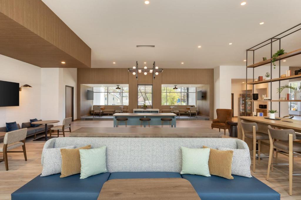 a living room with a couch and chairs at Staybridge Suites Rochester - Mayo Clinic Area, an IHG Hotel in Rochester