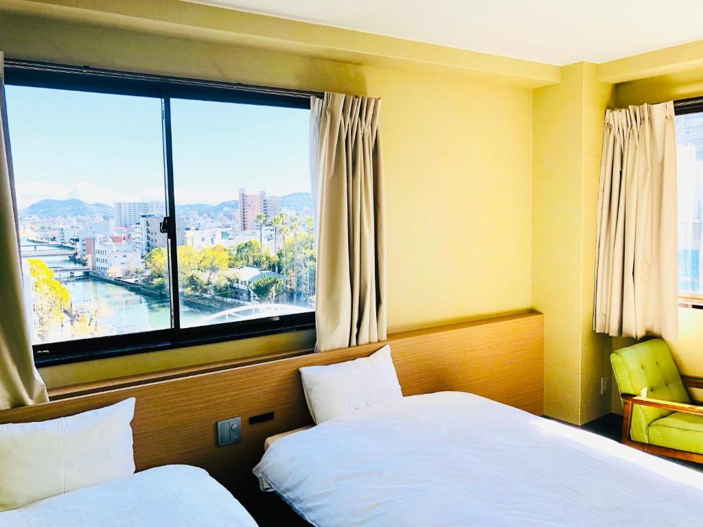 Postel nebo postele na pokoji v ubytování Hotel Takasago
