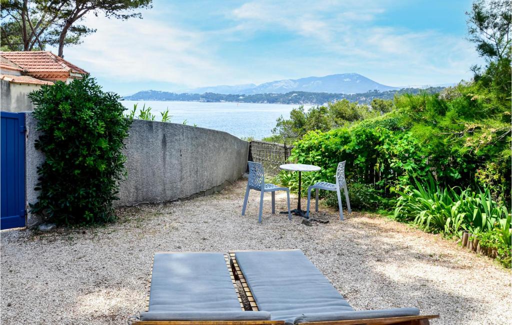 a patio with a table and chairs and the water at Stunning Home In Le Pradet With 1 Bedrooms And Wifi in Le Pradet