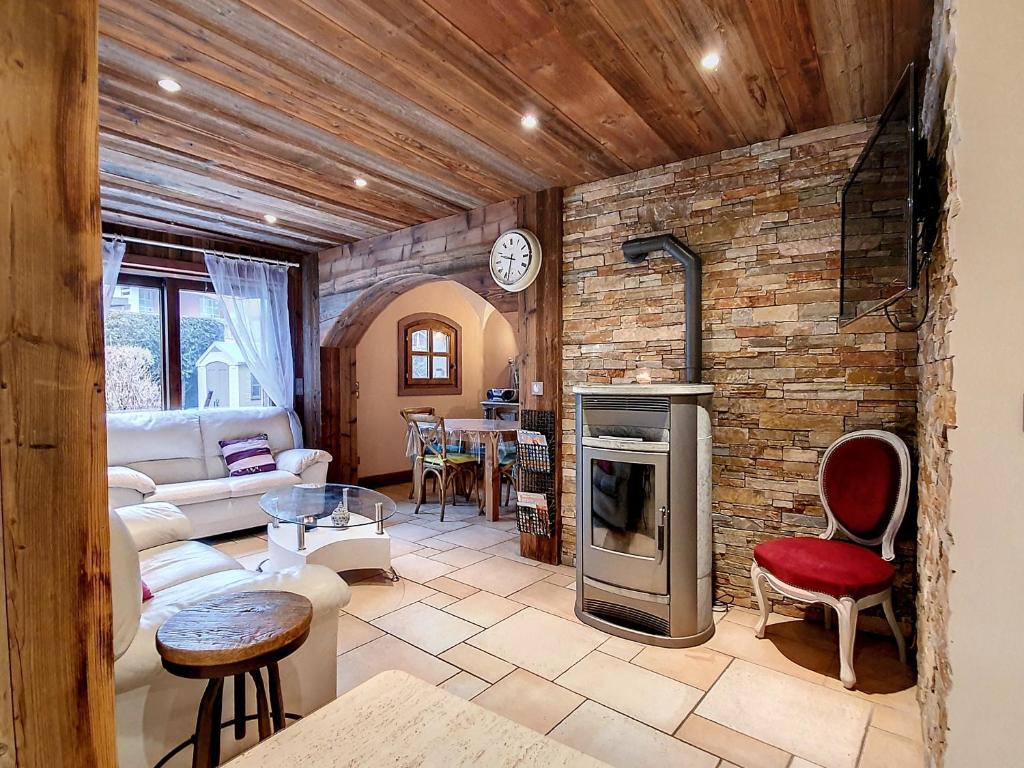 a living room with a brick wall at Appartement Favre 73 in Moutiers