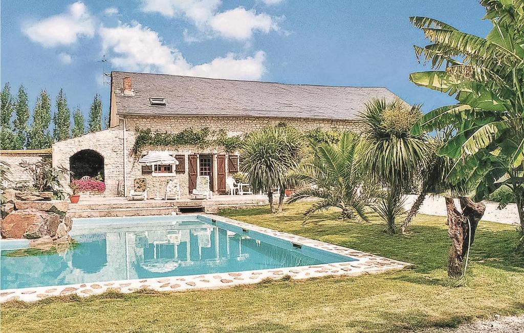 a house with a swimming pool in front of a house at Les Nouelles in Les Magnils