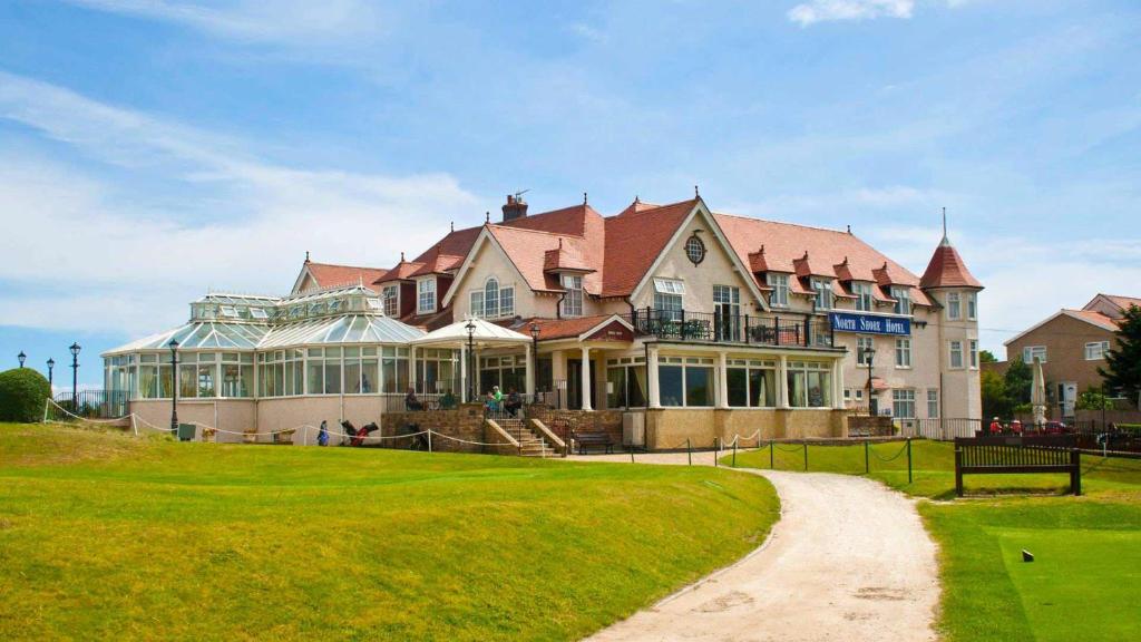 a large house with a lawn in front of it at North Shore Hotel in Skegness