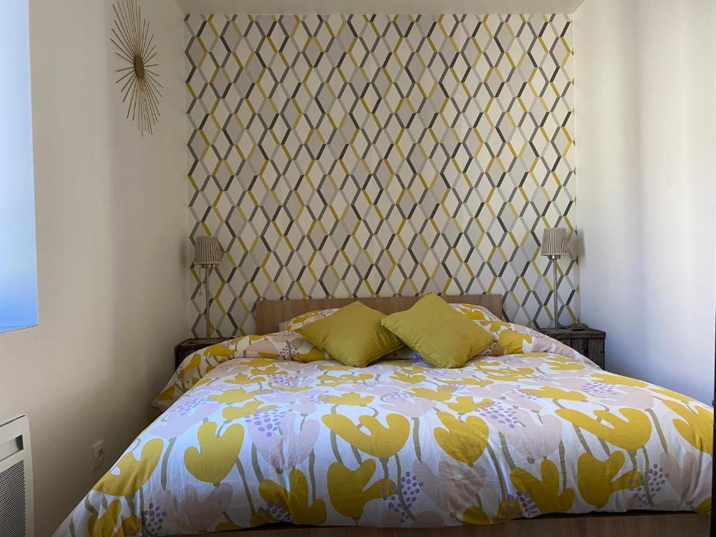 a bedroom with a bed with a patterned headboard at Appartements VIZILLE GRENOBLE - Route Napoleon in Vizille