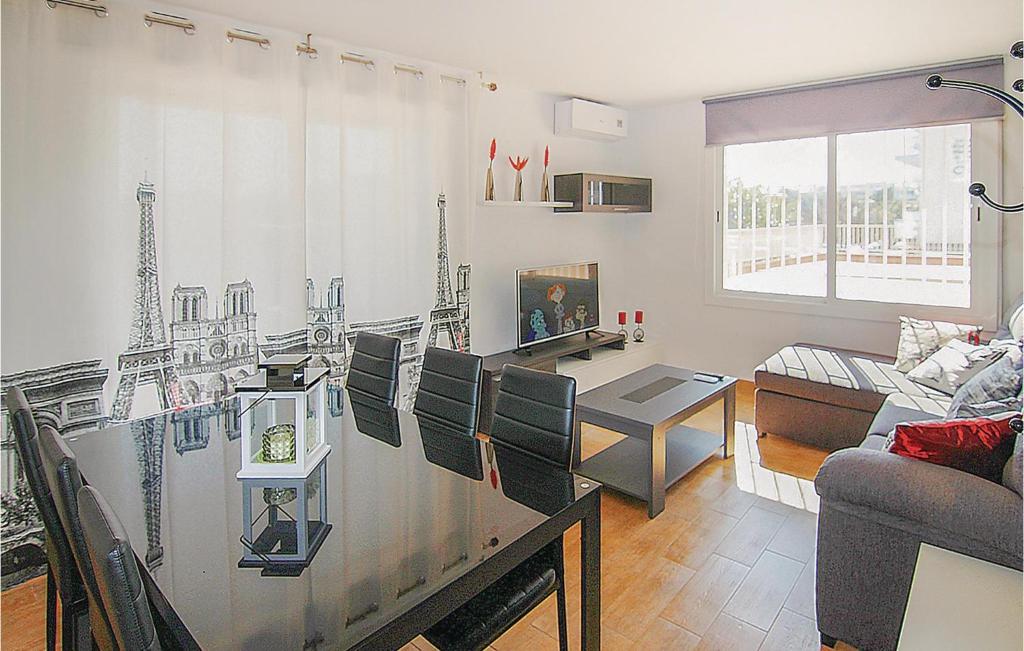 a living room with a kitchen and a living room with a table at Awesome Apartment In Malgrat De Mar in Malgrat de Mar