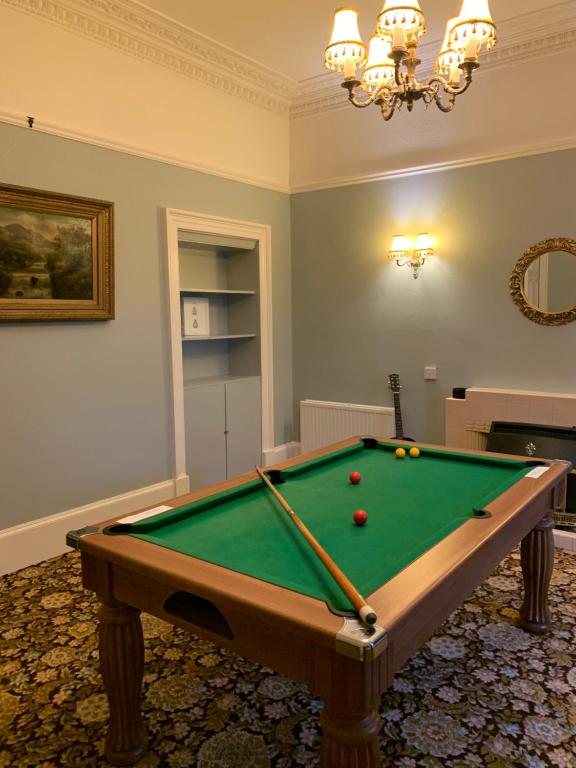 a room with a pool table with balls on it at Thurdistoft Farmhouse, Dunnetbay accommodation in Thurso