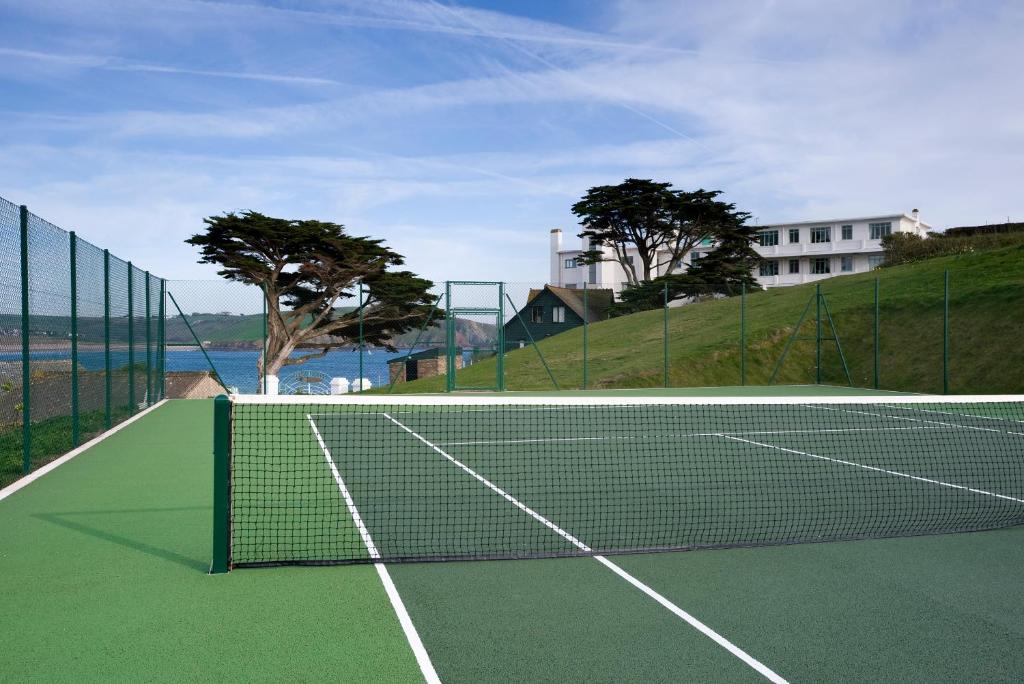a tennis court with a net on a tennis court at Burgh Island Hotel in Bigbury on Sea