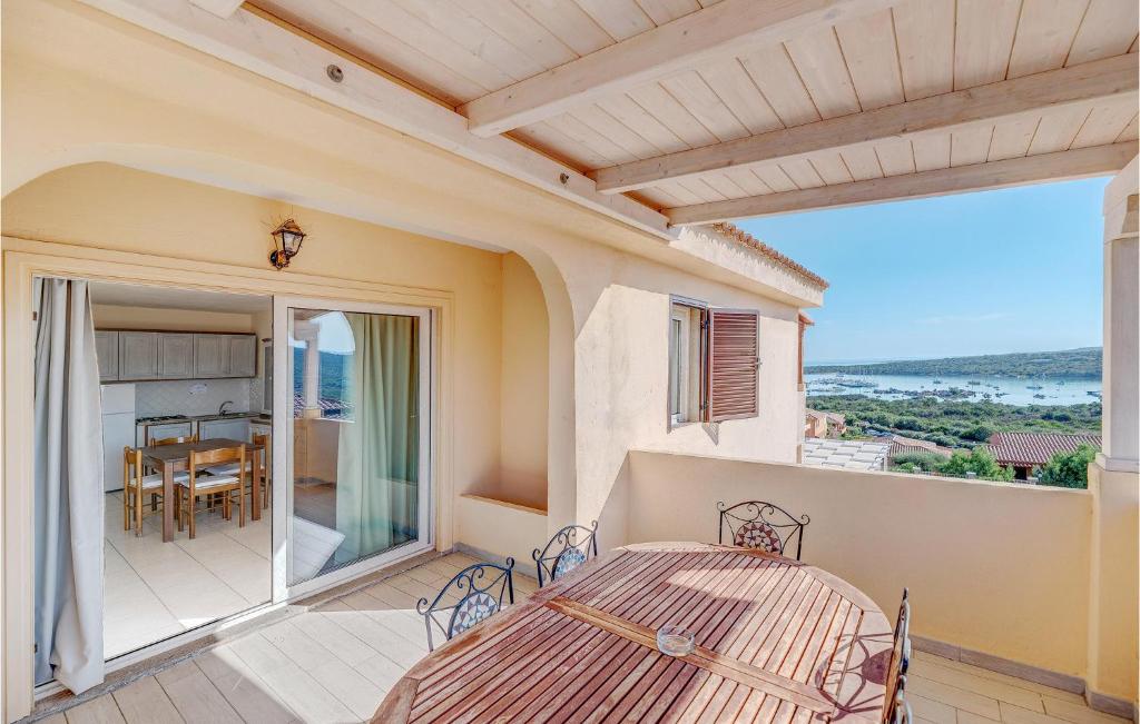 eine Terrasse mit einem Tisch und Stühlen auf dem Balkon in der Unterkunft Gorgeous Apartment In Golfo Aranci With Kitchenette in Golfo Aranci