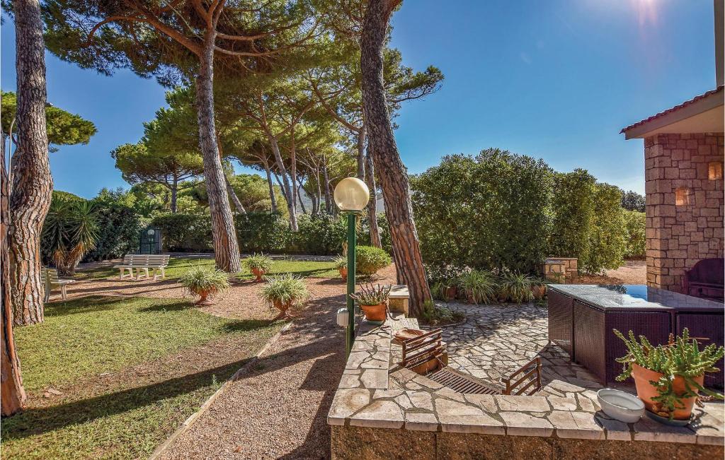 a garden with trees and a grill in a yard at Villa Arduino in Santa Liberata