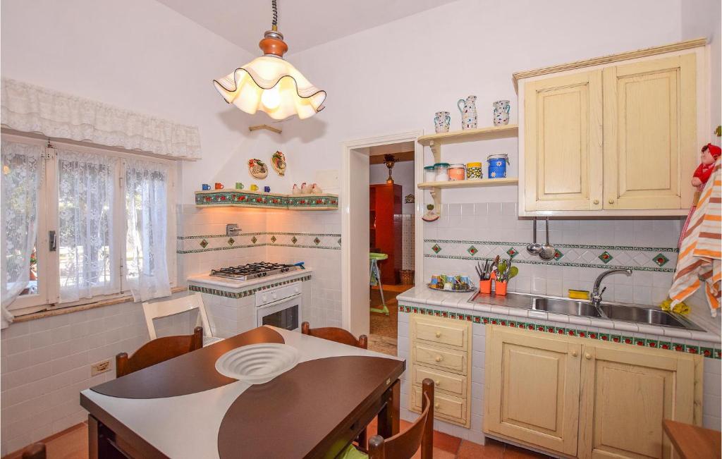 a kitchen with a sink and a table in it at Villa Arduino in Santa Liberata