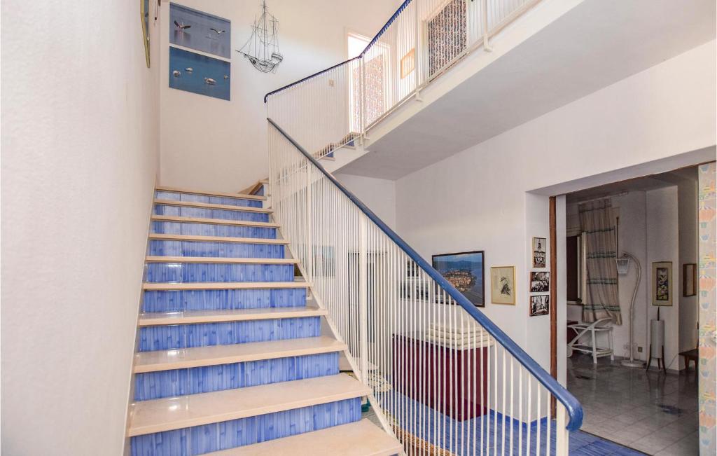 a staircase with blue treads in a house at Villa Arduino in Santa Liberata