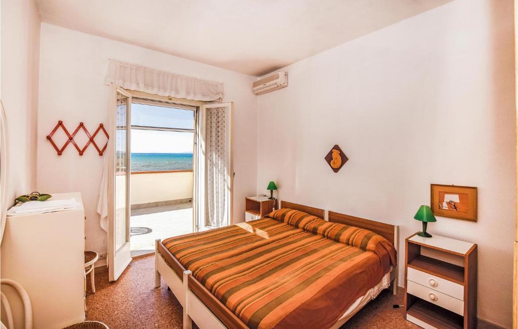 a bedroom with a bed with a view of the ocean at Villa Arduino in Santa Liberata
