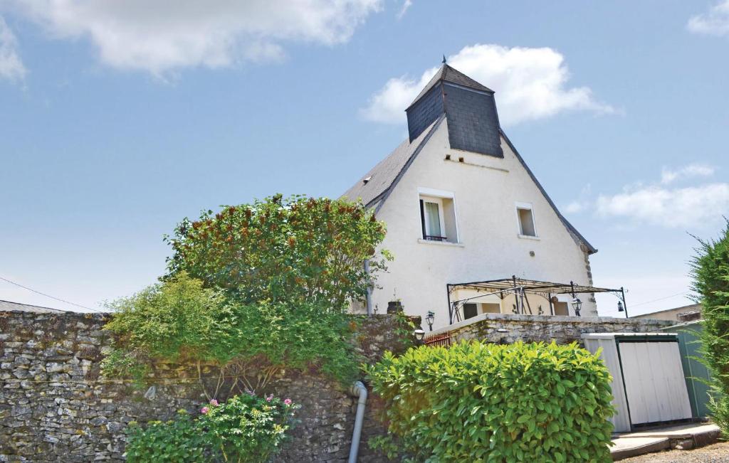 a white house on top of a stone wall at Amazing Home In Ladornac With Kitchen in La Dornac