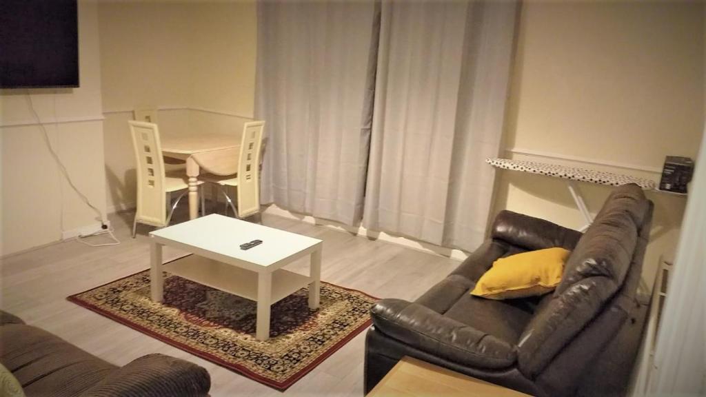a living room with a couch and a table at London Zone 1, 3bedroom Maisonette with a view in London