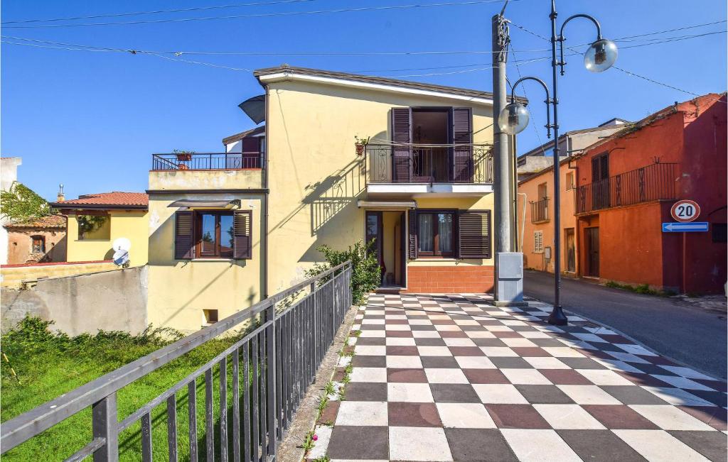 a street with a checkered sidewalk in front of a building at Amazing Apartment In Ricadi With House Sea View in Ricadi