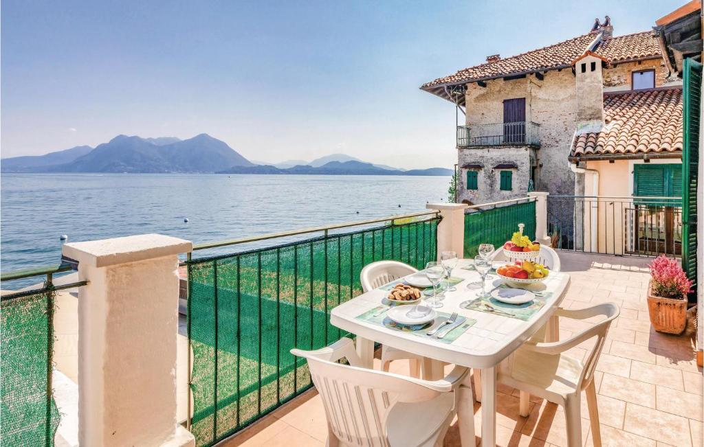 a table on a balcony with a view of the water at C Del Pepi in Stresa