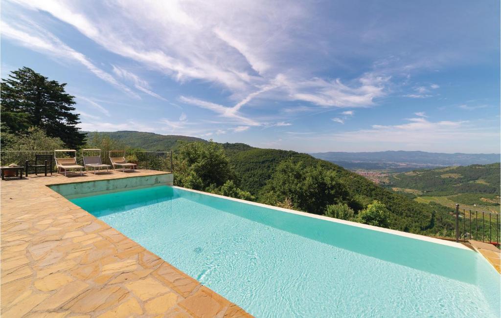 a swimming pool with a view of the mountains at Casetta Ind in Loro Ciuffenna